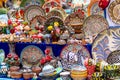 Ornate colorful oriental dishes and ceramics on market window. Silk Road