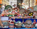 Ornate colorful oriental dishes and ceramics on market window. Silk Road