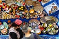 Ornate colorful oriental tableware and ceramics in market window. Seller and buyer. Silk Road