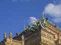 Ornate corner detail Prague National Theater Building with Bronze three horse chariot on top of roof and stone female