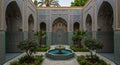 Ornate courtyard features intricately tiled walls with Arabic script, showcasing Royalty Free Stock Photo