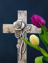 Ornate cross with tulips on a dark background. Condolence card.