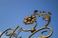 Ornate decorative elements of metal gate processing against the blue sky background Royalty Free Stock Photo