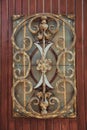 Ornate decorative wrought iron elements on the wood door