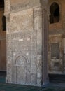 Stone wall with engraved floral patterns and calligraphy in front of the foundation stone of Ahmed Ibn Tulun Mosque, Cairo, Egypt Royalty Free Stock Photo