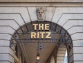 Ornate entrance to the iconic Ritz building, featuring a golden-lettered sign on the arched doorway