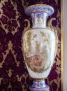 Ornate European ceramic vase with exquisitely painted scene