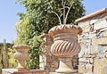 Ornate flower clay pots feature stone wall Royalty Free Stock Photo