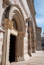 Ornate front gate of the rebuilt Romanesque basilica di Santa Maria di Collemaggio in L\'Aquila, Italy