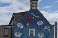 Ornate gable end of a house with daisies