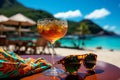 An ornate glass of an exotic drink on a table, a colorful scarf and sunglasses in an exotic resort Royalty Free Stock Photo