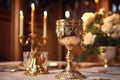 Ornate gold chalice on altar with candles and roses