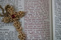 Ornate gold cross on open Bible