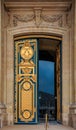 Ornate golden door with fleur de lis pattern at the entrance of Les Invalides in Paris France burial site of Napoleon Bonaparte