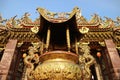 Golden Incense Burner in front of a Chinese Buddhist Shrine Royalty Free Stock Photo