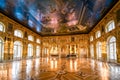 An ornate golden interior ballroom with a grand piano inside the Rococo Catherine Palace at Pushkin near St. Petersburg, Russia