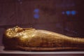 Ornate golden mummy displayed in an exhibit at the Egyptian Museum in Cairo, Egypt