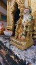 Ornate golden statue of Confucius in a traditional Khmer shrine in the town of Kampot, Cambodia