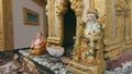 Ornate golden statue of Confucius in a traditional Khmer shrine in the town of Kampot, Cambodia