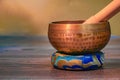 Ornate, hand-hammered Tibetan bell on a golden background