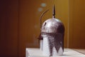 Ornate helmet with an intricate design behind a museum glass in Cairo, Egypt