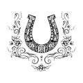 Ornate horseshoe with flowers and flourishes around, sketchy ink hand drawn design element. Grungy tattoo, zentangle style symbol