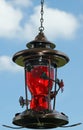 Ornate Hummingbird Feeder against a blue sky