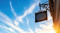 Ornate iron distillery sign against blue sky at sunset Royalty Free Stock Photo
