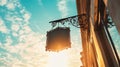 Ornate iron distillery sign at sunset against a vibrant sky Royalty Free Stock Photo