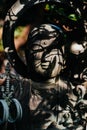 Ornate Japanese Buddhist Buddha statue shrine with greenery in urban Tokyo Japan. Royalty Free Stock Photo