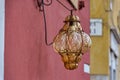 Ornate Lamp on Red Stucco House - Venice's Architectural Charm