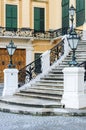 Ornate Lampss and Exterior Stairway with curving black metal railing and white stone at Shoenbrunn Castle, Vienna, Austria Royalty Free Stock Photo
