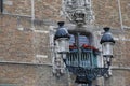 Ornate lantern against Belfort van Brugge wall