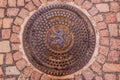 Ornate manhole cover with the Czech and Bohemian coat of arms wi