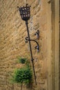 Ornate medieval sconce torch mount on an ancient stone wall in Olite, Spain