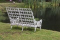 Ornate Metal Bench at Edge of Water Royalty Free Stock Photo