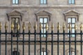 An ornate metal fence with gold-tipped spearhead finials