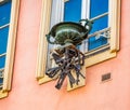 Ornate metal flower pot with selection of metal workmans tools hanging underneath