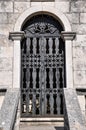 An ornate metal gate featuring a stylised skull at the entrance to a tomb in the cemetery of Our Lady of the Angels Andela Monas