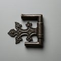 Ornate metal hinge with a Gothic design, featuring an intricate pattern of symmetrical Royalty Free Stock Photo