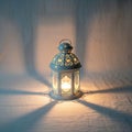 Ornate metal lantern casting intricate shadows on a textured surface Royalty Free Stock Photo