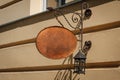 Ornate metal sign mock-up for store name on building facade exterior