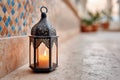Ornate middle eastern lantern with intricate patterns casting warm light, placed on a textured stone surface, creating a Royalty Free Stock Photo