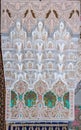 Ornate Moroccan plaster arabesque carving on a wall in a riad