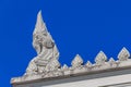 Ornate naga statue on the ornamented tiered ubosot roof of Wat Kaew Korawaram white buddhist temple in Krabi, Thailand