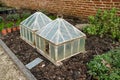 Ornate, old-style cold frames seen in a botanical gardens. Royalty Free Stock Photo