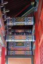 An ornate painted ceiling on a building in the Forbidden City in Beijing