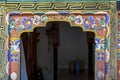 Ornate painted and decorated doorpost with dragons an flowers in Bhutanese style, Mongar, Bhutan