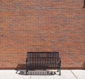 Ornate Public Steel Bench In Front of Brick Wall