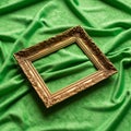 An ornate, rectangular gold picture frame with intricate floral patterns lies on a texture Royalty Free Stock Photo